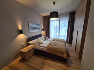 Posteľ alebo postele v izbe v ubytovaní Apartament D2 Karpatia - 5D Apartamenty