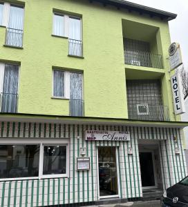 a yellow and green building with a store at Hotel Annis M&P in Dortmund