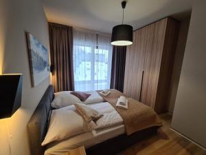 Posteľ alebo postele v izbe v ubytovaní Apartament D2 Karpatia - 5D Apartamenty