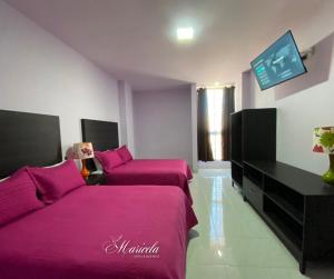 Postel nebo postele na pokoji v ubytování Hotel Maricela