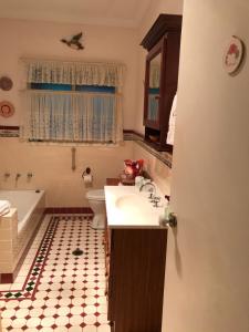 a bathroom with a sink and a tub and a toilet at Blue Gum Cottage on Bay in Bensville +22 photos