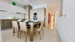 a kitchen with a dining room table and chairs at Quisisana Apartments - Cast Renting in Sliema