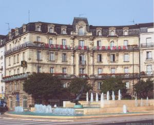 a large building with a fountain in front of it at Hôtel De France in Angers