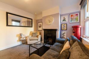 a living room with a couch and a fireplace at Springfield Place - 3 Bed Central Reading - Sleeps 6 - Free Parking in Reading