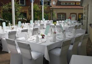 a set of white tables and chairs at a wedding at Landgasthof zur krummen Linde in Stolpe