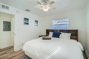a white bedroom with a bed and a ceiling fan at Hidden Oasis ** Stunning 2 BR ** Sunset Shores in West Palm Beach