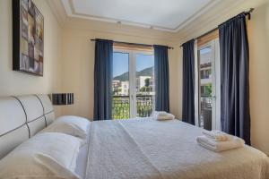 a bedroom with two beds and a large window at Porto Montenegro in Tivat