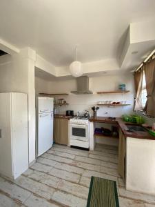 a kitchen with a white refrigerator and a stove at Complejo Santa Ana Miramar Buenos Aires in Miramar