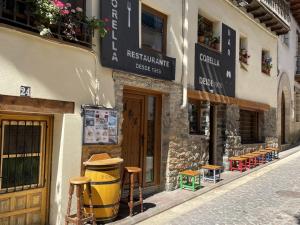 a building with stools on the side of a street at Apartamento Alcala de la selva in Alcalá de la Selva