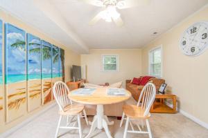a dining room with a table and chairs and a clock at Reilly Road Refuge in Fort Bragg