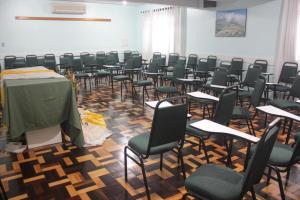 a room with a bunch of chairs and a table at Pousada Irmãs Franciscanas in Lages