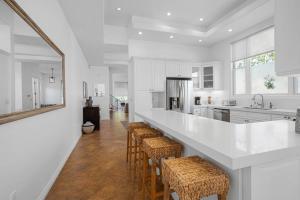 a kitchen with a bar with stools and a counter at Stunning TH #5 in Los Angeles