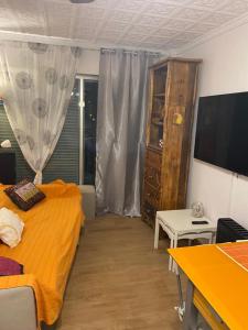 a bedroom with a bed and a dresser and a television at Apartamento con vistas al mar in Puerto de Mazarrón
