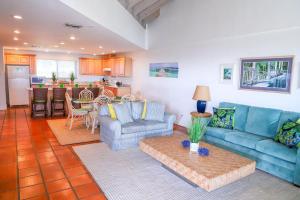 a living room with a couch and a table at Latitude Penthouse Key West in Key West