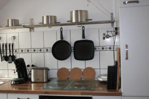 a kitchen with pots and pans hanging on the wall at Ferienwohnung Hardtblick in Wuppertal