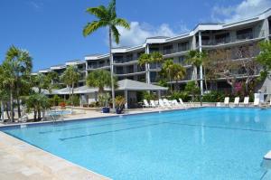 a swimming pool in front of a resort at Latitude Penthouse Key West in Key West