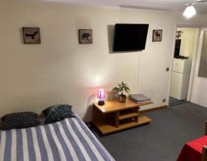 a bedroom with a bed and a table with a lamp at Sky apartments FREE PARKING in Wrocław