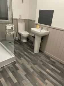 a bathroom with a sink and a toilet at The Willows in Brighouse