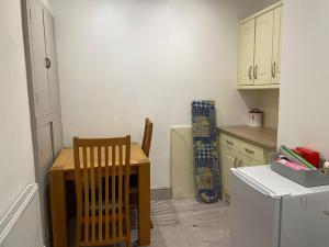 a kitchen with a table and chairs in a kitchen at The Willows in Brighouse