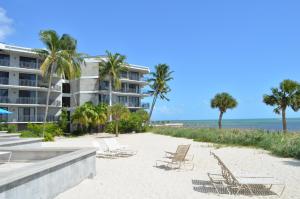 a beach with chairs and a building and the ocean at Atlantic Oasis on the Ocean in Key West