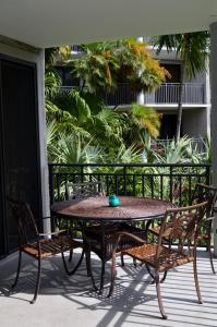a table and chairs on a patio with a table at Paradise Found Cayo Hueso in Key West