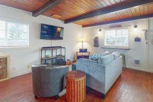 a living room with two couches and a table at Bay Bliss in Reedsport