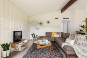 a living room with a couch and a tv at Quiet Haven with Huge Fenced Yard Fast Internet by Lodgewell in Austin