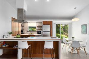a kitchen with white counters and white chairs at Quiet Haven with Huge Fenced Yard Fast Internet by Lodgewell in Austin