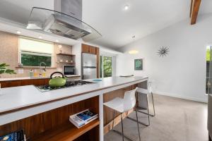 a kitchen with a counter and a stove top oven at Quiet Haven with Huge Fenced Yard Fast Internet by Lodgewell in Austin