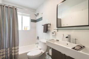 a bathroom with a sink and a toilet and a mirror at Quiet Haven with Huge Fenced Yard Fast Internet by Lodgewell in Austin