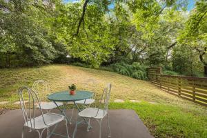 a table and chairs sitting on a patio at Quiet Haven with Huge Fenced Yard Fast Internet by Lodgewell in Austin