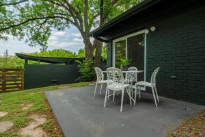 a table and chairs sitting on a patio at Quiet Haven with Huge Fenced Yard Fast Internet by Lodgewell in Austin