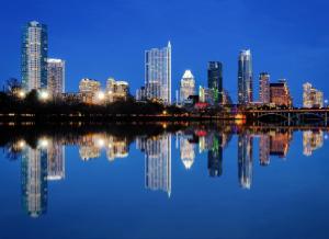 a view of a city skyline at night at Quiet Haven with Huge Fenced Yard Fast Internet by Lodgewell in Austin