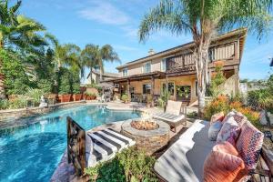 a home with a swimming pool and a house at Vino Villa Large home Sleeps 10! Large Salt water pool/spa in Murrieta