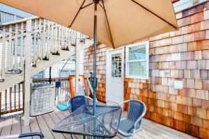 a patio with a table and chairs and an umbrella at Ocean City Stunner & Charmer in Ocean City