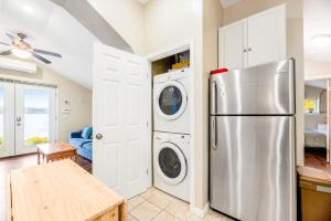 a kitchen with a refrigerator and a washer and dryer at Live Laugh Lake - A in Rushville