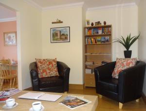 uma sala de estar com duas cadeiras e uma mesa em Bunratty Haven Bed & Breakfast em Bunratty