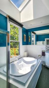 a large bathroom with a large tub and a window at Elroma, a grand Federation house in Hepburn Springs in Hepburn Springs