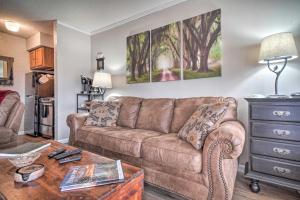 a living room with a brown couch and a table at Studio about 3 Mi to Great Smoky Mountain Natl Park! in Gatlinburg