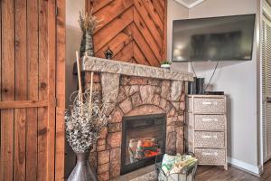 a brick fireplace with a tv on top of it at Studio about 3 Mi to Great Smoky Mountain Natl Park! in Gatlinburg