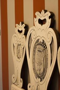 two white mirrors sitting on top of a shelf at Palazzo Bellini in Turin