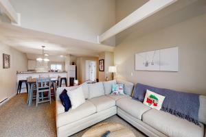 a living room with a couch and a kitchen at Trailside 19BU & 19BL in Ludlow