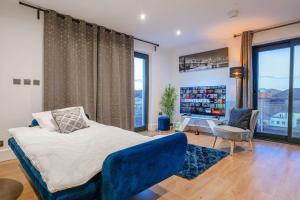 a bedroom with a bed and a large window at NEW Stunning Rooftop Terrace Flat-Town Centre in Kent