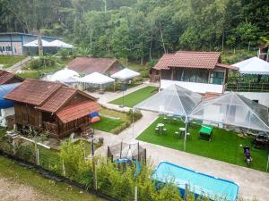 an aerial view of a house with tents and a yard at Genting Greenwoods Tiny Houses & Events Hall in Genting Highlands