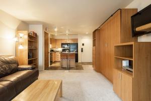 a living room with a couch and a kitchen at SNOW FLOWER 066-Studio condo in Park City