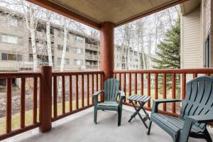 two chairs and a table on a porch at SNOW FLOWER 066-Studio condo in Park City