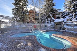 a swimming pool in the snow in front of a building at SNOW FLOWER 066-Studio condo in Park City