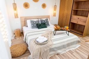 a bedroom with a bed with a table on it at Antonakis Villa, Near Beach, Private Pool in Kremasti