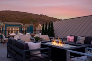 a patio with chairs and a fire pit on a roof at LIFT LODGE 102 condo in Park City