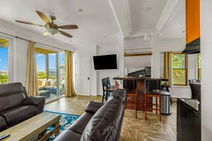 a living room with a couch and a flat screen tv at 34 Champlain Unit 1 and Penthouse in Ocean Bay Park